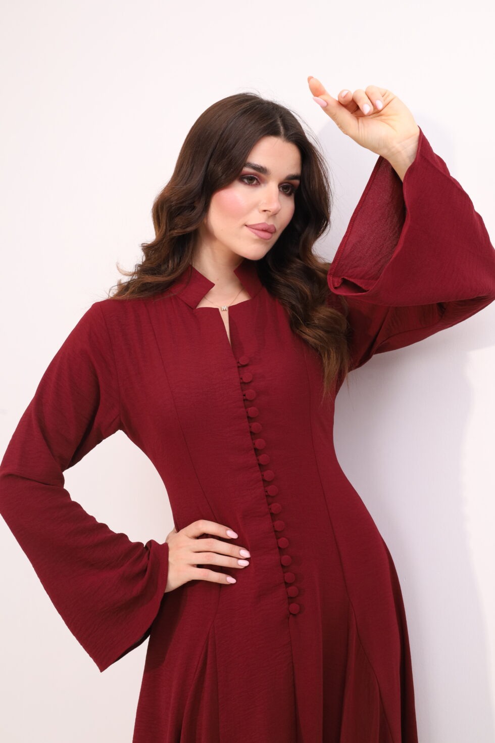 Burgundy maxi dress, elegant modest dress, button detail gown, long sleeve evening dress, formal occasion wear, luxury modest fashion, sophisticated women’s fashion, flowing burgundy gown, timeless elegant dress, wedding guest outfit.