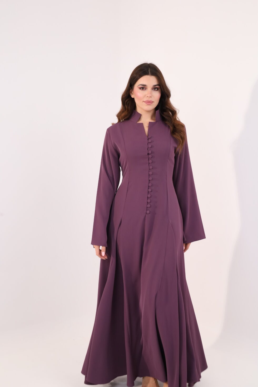 Plum purple maxi dress, elegant modest dress, button detail gown, long sleeve evening dress, formal occasion wear, luxury modest fashion, flowing purple gown, sophisticated women’s fashion, timeless elegant dress, wedding guest outfit.