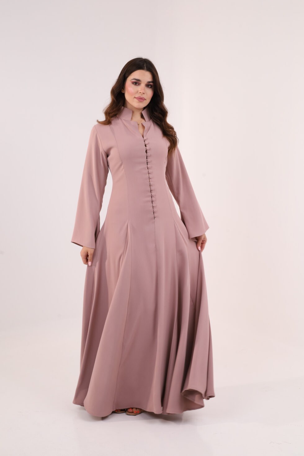 Dusty pink maxi dress, elegant modest dress, button detail gown, long sleeve evening dress, formal occasion wear, luxury modest fashion, flowing pink gown, sophisticated women’s fashion, timeless elegant dress, wedding guest outfit.
