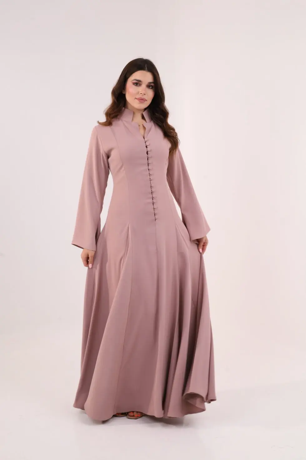 Dusty pink maxi dress, elegant modest dress, button detail gown, long sleeve evening dress, formal occasion wear, luxury modest fashion, flowing pink gown, sophisticated women’s fashion, timeless elegant dress, wedding guest outfit.