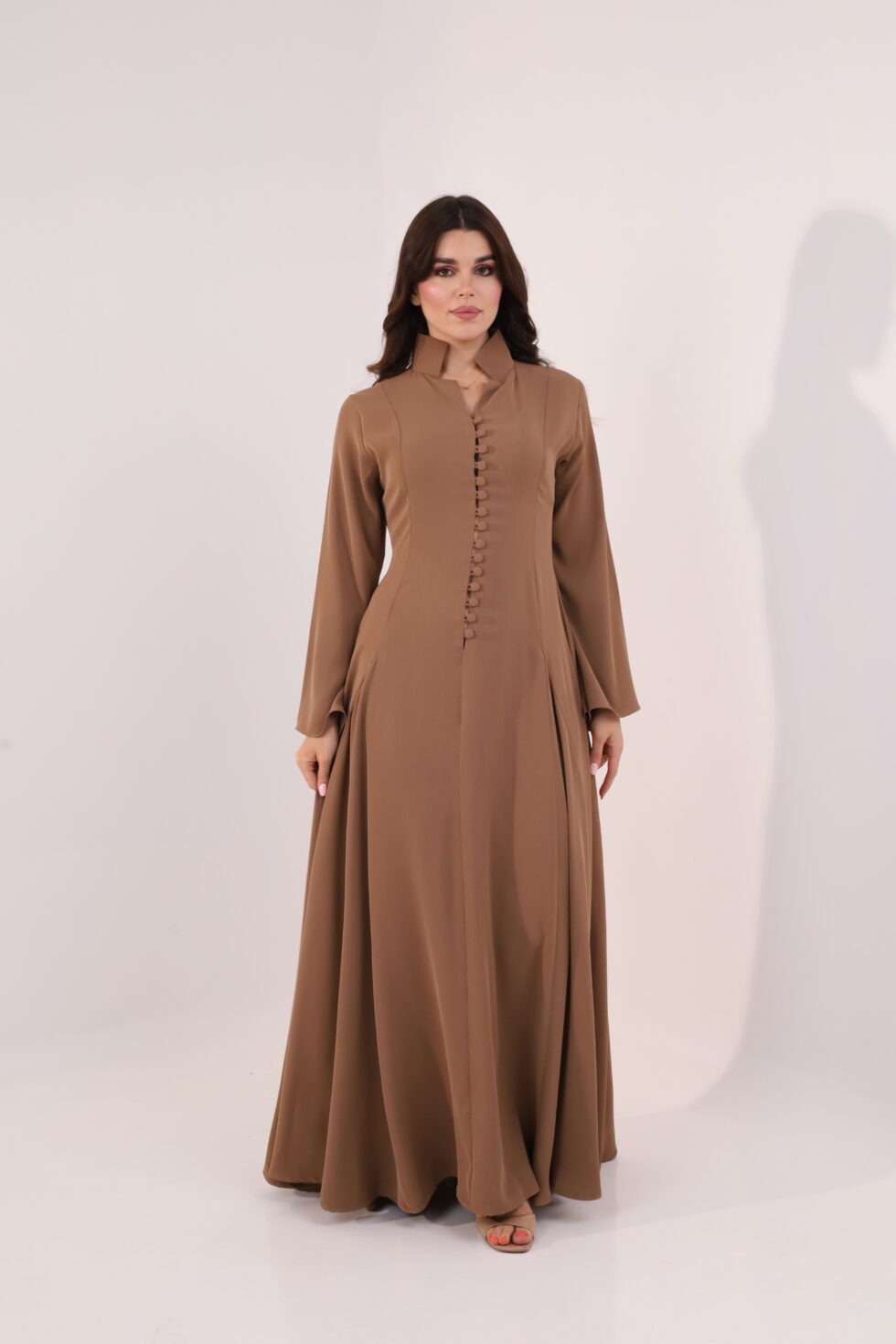 Mocha brown maxi dress, elegant modest dress, button detail gown, long sleeve evening dress, formal occasion wear, luxury modest fashion, flowing brown gown, sophisticated women’s fashion, timeless elegant dress, wedding guest outfit.